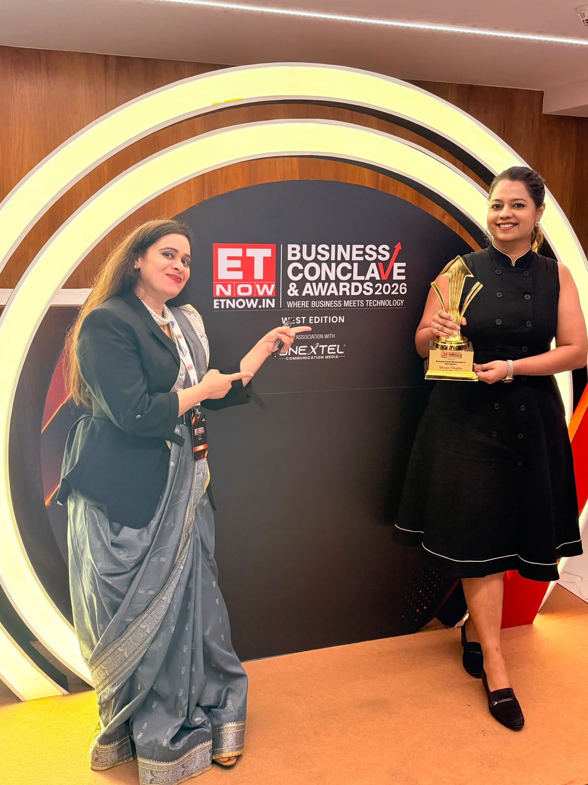 Shivani Tikadia with a SecComply colleague beside the ETNOW.in Business Conclave and Awards 2026 West Edition backdrop