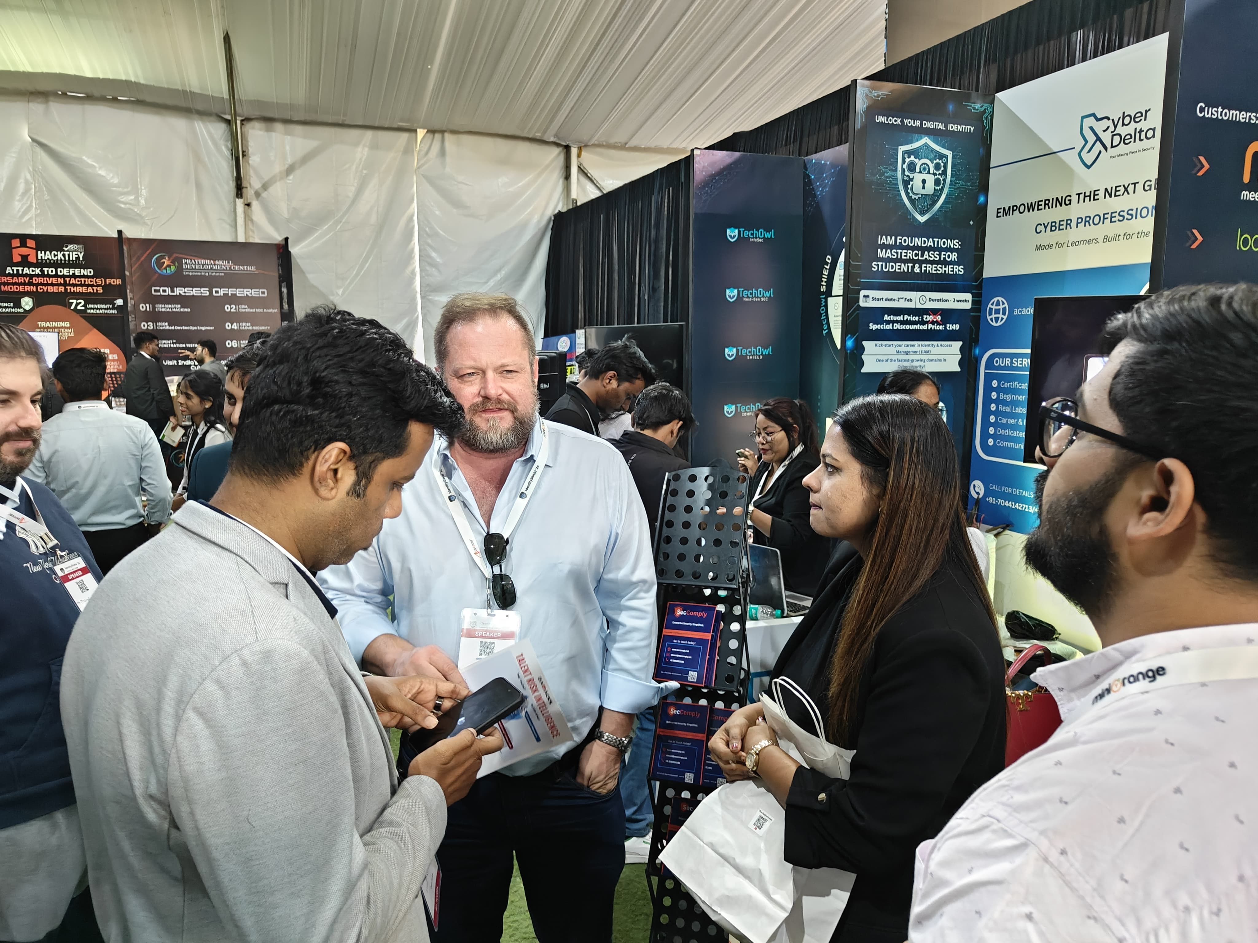 Full SecComply team photo in front of the booth